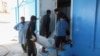 People carry the body of a migrant, whose boat sank in the sea, after the Libyan Coast Guards took them out from the Mediterranean Sea, in Garaboli, Libya, April 25, 2023. 
