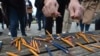 Journalists breaks pencils during a protest outside the parliament during the session about controversial amendments to the criminal code that would make defamation a crime punishable with stiff fines, in the Bosnian town of Banja Luka, March 14, 2023. 