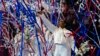 FILE - Simone Biles and the U.S. women celebrate as the 2024 team is named at the United States Gymnastics Olympic Trials in Minneapolis, June 30, 2024.