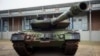 FILE - A Leopard 2 main battle tank is parking in front of a facility at the German forces Bundeswehr training area in Munster, Germany, Feb. 20, 2023. 
