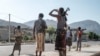 FILE - Members of the Afar militia stand in a checkpoint at the entrance of the town of Abala, 480 kilometers of Semera, Ethiopia, June 08, 2022.
