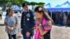 Yoko Sakato, left, and Valerie Matsunaga, right, relatives of soldiers who fought in the 442nd Infantry Regiment during World War II, are flanked by U.S. Army Staff Sgt. Michael A. Rosado, at Camp Darby, Tuscany, Italy, July 11, 2024.