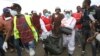 Rescuers carry sacks with human remains after being removed from a quarry in Mukuru Kwa Njenga area in Nairobi, Kenya, July 13, 2024. 