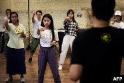 Guru seni bela diri Mic Leung (kanan) mengajar Wing Tsun di Fringe Club di kawasan pusat kota Hong Kong, 15 Juli 2023, menjelang peringatan 50 tahun kematian Bruce Lee, 20 Juli 2023. (May JAMES / AFP)