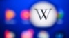 A picture taken on April 15, 2022 in Moscow shows the Wikipedia logo on a tablet screen. 