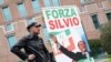 A supporter of former Italian Prime Minister Silvio Berlusconi stands near the hospital where Berlusconi is hospitalized, in Milan, Italy, April 7, 2023. 