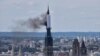 Smoke billows from the spire of Rouen Cathedral in Rouen, northern France on July 11, 2024. 