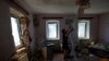 Resident Natalia removes debris in a house damaged by recent shelling in the course of Russia-Ukraine conflict in the Donetsk region, Russian-controlled Ukraine, July 6, 2024.