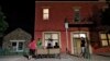 FILE - Migrants socialize outside Annunciation House, June 26, 2018, in El Paso, Texas. A Texas judge ruled against the state attorney general on July 2, 2024, in his effort to shut down a the shelter, which he claimed encourages illegal migration.