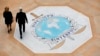 FILE - People walk on the Interpol logo at the agency headquarters in Lyon, France, Nov. 8, 2018. 'The volume of financial fraud stemming from West Africa is alarming and increasing,' says Isaac Oginni, director of Interpol's Financial Crime and Anti-Corruption Centre.