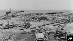 This image provided by Naval History and Heritage Command shows the wreckage of the Building A-7 Joiner Shop in the center and munitions pier beyond, from the July 17, 1944 explosion at Port Chicago naval weapons station near San Francisco. 