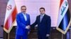 In this handout photo released by Iraq's National Security Council press office, Iraq's National Security Adviser Qasim al-Araji (R) welcomes the Secretary of Iran's Supreme National Security Council Ali Shamkhani, in Baghdad, Iraq, March 19, 2023.
