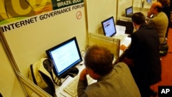 FILE - People use the internet during an internet governance forum in Rio de Janeiro, Brazil, Nov. 12, 2007.