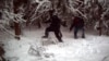 FILE - In this surveillance image provided by the United States Border Patrol Swanton sector, two individuals illegally cross the U.S./Canada border during January 2023 in the Vermont, New Hampshire and New York enforcement sector. 