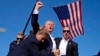 FILE - Republican presidential candidate former president Donald Trump is surrounded by U.S. Secret Service agents after an assassination attempt in Butler, Pennsylvania, July 13, 2024. His campaign has not discussed, or released a medical report or records about his condition.