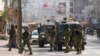 Israeli soldiers take up positions at the scene of a Palestinian shooting attack at the Hawara checkpoint, near the West Bank city of Nablus, Feb. 26, 2023.