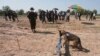 FILE - A dog sniffs COVID19 scents during a demonstration while Ukrainian deminers tour the Peace Museum Mine Action in Siem Reap province, northwestern Cambodia, Jan. 20, 2023.