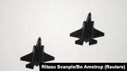 FILE - Two F-35 fighter jets return to air base Flyvestation Skrydstrup after patrolling around Denmark at low altitude, Oct. 1, 2023.