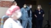 FILE - Nurses stand in a hospital doorway watching a nurses’ protest demanding better personal protective equipment, at UCLA Medical Center, during the coronavirus pandemic, in Los Angeles, California, April 13, 2020.