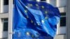 FILE - European Union flags fly outside the European Commission headquarters in Brussels, Belgium, March 1, 2023.