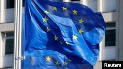 FILE - European Union flags fly outside the European Commission headquarters in Brussels, Belgium, March 1, 2023.