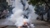 FILE - A protester runs from tear gas fired by police in Nairobi, Kenya, July 16, 2024. Kenya's High Court on Thursday suspended a police ban on protests in the capital, stating citizens have a right to demonstrate peacefully. 