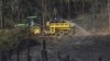 FILE - Firemen douse a wildfire in Howick, near Durban, South Africa, July 10, 2024. South Africa's emergency services said July 15, 2024, that several firefighters have died battling a bushfire in the eastern KwaZulu-Natal province and others are in a critical condition.