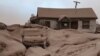 A house and car are seen covered in volcanic dust following the eruption of the Shiveluch volcano in the Kamchatka region of Russia's Far East, April 11, 2023. (Institute of Volcanology and Seismology/Handout via Reuters)