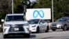 Cars drive past a Meta sign outside of the company's headquarters in Menlo Park, Calif., March 7, 2023.