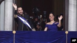 FILE - El Salvador's President Nayib Bukele and first lady Gabriela Roberta Rodríguez wave from a balcony after he was sworn in for a second term, in San Salvador, El Salvador, June 1, 2024. 