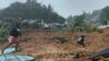 People inspecting the damage at a village that was hit by landslides in Natuna in Indonesia's Riau Province, March 6, 2023. (National Disaster Management Agency/AFP).