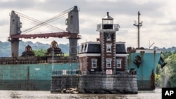 A ship passes the Hudson Athens Lighthouse, June 12, 2024, in Hudson, New York.