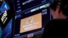 A trader works at the post where Alibaba is traded on the floor of the New York Stock Exchange in New York, March 28, 2023.