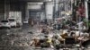 Residents look at their belongings in the aftermath of Typhoon Gaemi in Manila on July 25, 2024.