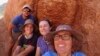 In this undated photo provided to the Associated Press by Stellenbosch University, researcher Michele Francis, right, and other researchers pose next to an ancient termite mound in Namaqualand, South Africa. 