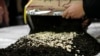 FILE - Confiscated captagon pills that were hidden in 434 boxes mixed with seven tons of tea for export are put on display at police headquarters in Beirut, Lebanon, Jan. 25, 2022.