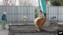 FILE - A power shovel is used on Feb. 21, 2011, to dig at the site of a former medical school in Tokyo linked to Unit 731, a germ and biological warfare outfit during World War II.