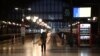 FILE - A traveler waits in front of platforms at Gare du Nord train station during nationwide strikes and protests against the government's pension reform plan, in Paris, France, Jan. 31, 2023.
