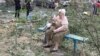 A resident sits near her residential building damaged by a Russian missile strike in Mykolaiv, Ukraine, July 19, 2024. Russian drones and missiles struck Ukraine overnight, killing two and hitting energy facilities and railway infrastructure across the country, said officials. 