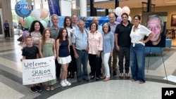 Shalom Korai, standing fourth from left in the front row, poses for a photo with members of his extended family shortly after he met them for the first time in North Charleston, South Carolina, July 10, 2024.