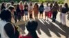 FILE - Supporters of a lawsuit challenging a Hawaii midwife licensure law gather outside a courthouse in Honolulu, June 10, 2024.
