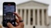 FILE - A person shoots with a mobile at the U.S. Supreme Court building in Washington, Oct. 31, 2022.