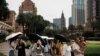 Visitors take pictures in front of a replica of Big Ben at the Londoner Macao casino resort, which is operated by Sands China, during Labor Day holiday in Macao, China, April 30, 2023. 