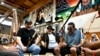 Mark Erickson, third from left, leads others in singing on the drum during an open drum and dance night at Minneapolis American Indian Center, July 10, 2024, in Minneapolis, Minnesota.