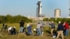 Photographers set up cameras to cover the launch of the SpaceX Falcon 9 rocket with the crew capsule Endeavour as it stands ready at the Kennedy Space Center in Cape Canaveral, Florida, Feb. 26, 2023.