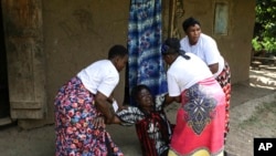 Eva Bulimpikya, center, with Soul Sisters members in action during a gender violence skit at Bundibugyo district, Western Uganda, June 29, 2024.
