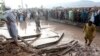People gather to clear the rubble of a house partially damaged by landslide due to heavy rainfall in Surkhroad district of Jalalabad, Nangarhar province east of Kabul, Afghanistan, July 15, 2024.