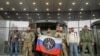FILE - Visitors pose outside PMC Wagner Center, which is a project implemented by the founder of the Wagner private military group, Yevgeny Prigozhin, during the official opening of the office block in Saint Petersburg, Russia, Nov. 4, 2022. 