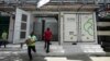 FILE - A worker walks in front of the 500-kilowatt battery energy storage system inside the Hindustan Coca-Cola Beverages factory in Thiruvallur district, on the outskirts of Chennai, India, July 16, 2024. 