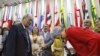 Eneá de Stutz e Almeida, right, president of the Amnesty Commission, bows as she apologizes in Brasilia, Brazil, July 25, 2024.